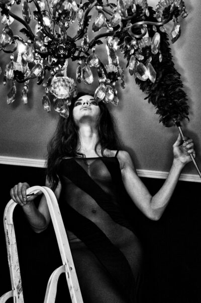 Woman dusting chandelier, Rome, 2011